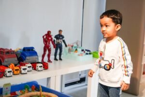 "Avengers: Doomsday and Love—How the Greatest Battles Are Fought with the Heart" 2 "Avengers: Doomsday and Love—How the Greatest Battles Are Fought with the Heart".Young boy playing with toy cars and action figures at home.