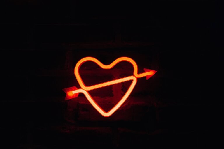 Love and the Future: Navigating Relationships in a Changing World.A glowing neon heart with an arrow on a dark background, perfect for romantic themes.