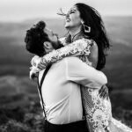The Unyielding Power of Love.(grayscale photography of man and woman hugging near hill)