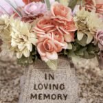 Embracing Health in the Face of Mortality: Understanding Life, Death, and Well-being..pink and white flowers on gray concrete tomb