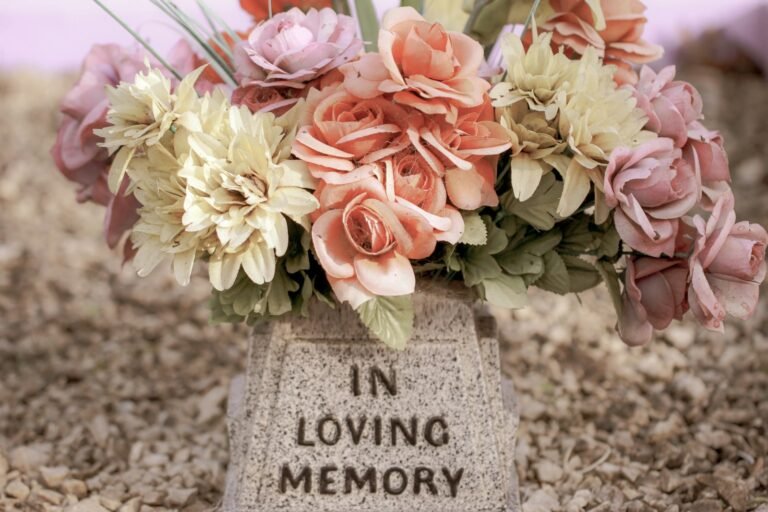 Embracing Health in the Face of Mortality: Understanding Life, Death, and Well-being..pink and white flowers on gray concrete tomb