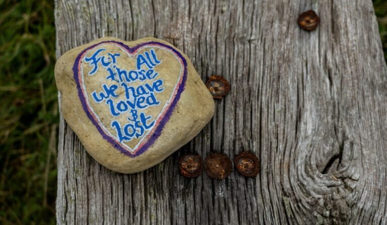 The memory of love continues in our soul. .a heart shaped rock with a message written on it