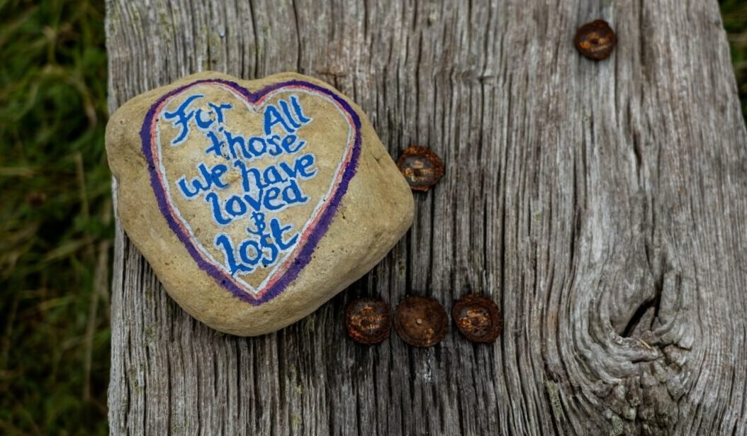 The memory of love continues in our soul. .a heart shaped rock with a message written on it