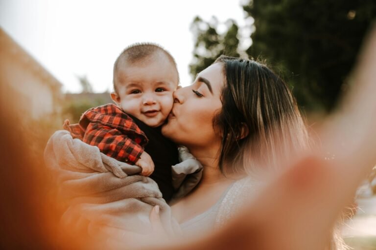 "Health and Love is a Powerful Force: How It Heals, Unites, and Transforms Lives"(woman kiss a baby while taking picture)