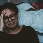Love and Health:Navigating the Depths of Depression.(person crying beside bed)