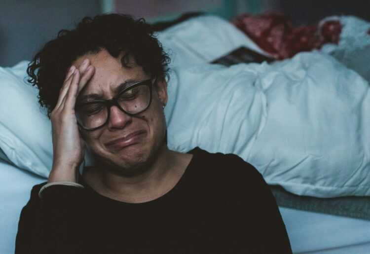 Love and Health:Navigating the Depths of Depression.(person crying beside bed)