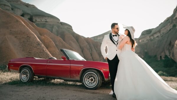 Love and Health Future: 10 Ways Love Is Good for Your Health.(Elegant couple poses beside a classic red convertible in a rocky landscape.)