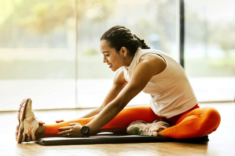 Transform Your Life with Love and Health: 25 Wellness Tips for a Vibrant Future(A woman enjoying a yoga stretch indoors, promoting a healthy lifestyle.)