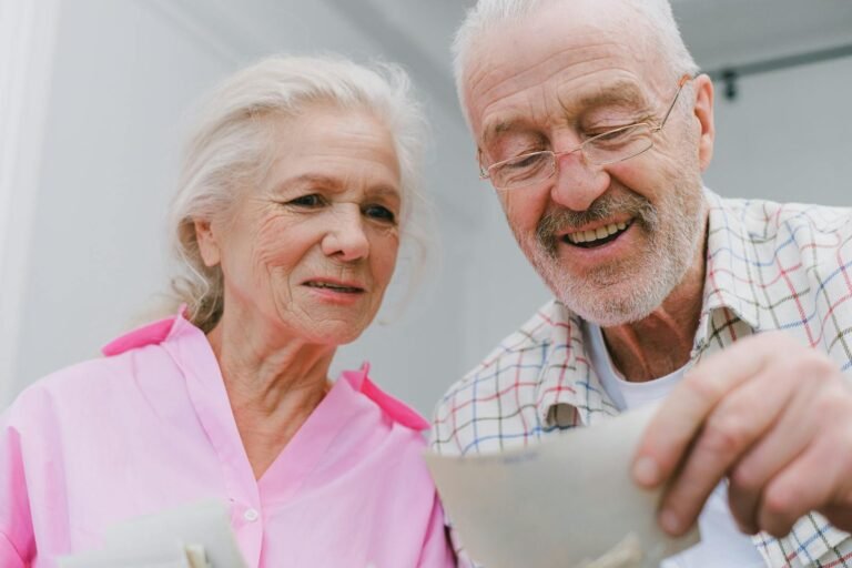Love and Memory: Woven Threads of the Heart – A Deep Dive into Emotional Memories, Relationship Growth, and Healing Through Nostalgia(Happy senior couple enjoying old photographs and sharing memories together.)