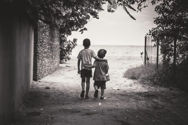 Love and Health: The Unbreakable Bond of Brothers – Elder and Younger 2 Love and Health: The Unbreakable Bond of Brothers – Elder and Younger. grayscale photography of child and toddler while walking