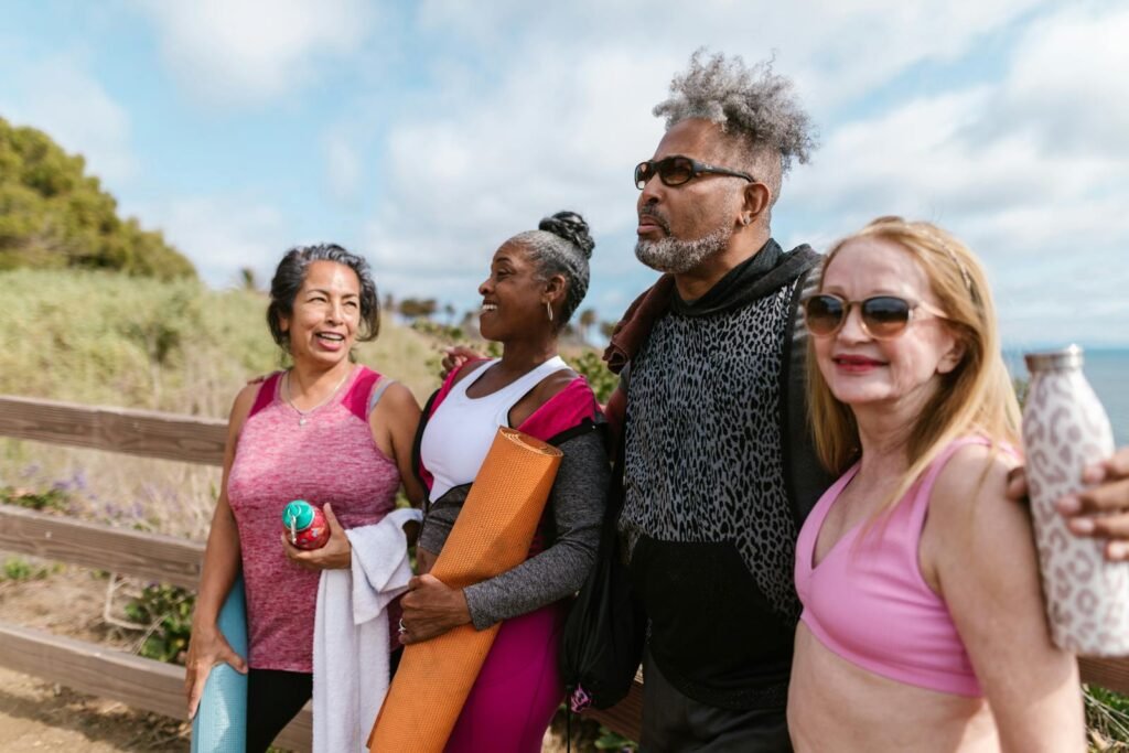 10 Timeless Tips for Lifelong Love & Wellness: A Guide to Loving Your Health at Any Age 2 10 Timeless Tips for Lifelong Love & Wellness: A Guide to Loving Your Health at Any Age.(Happy seniors gather outdoors for a group yoga session, embracing friendship and wellness.)