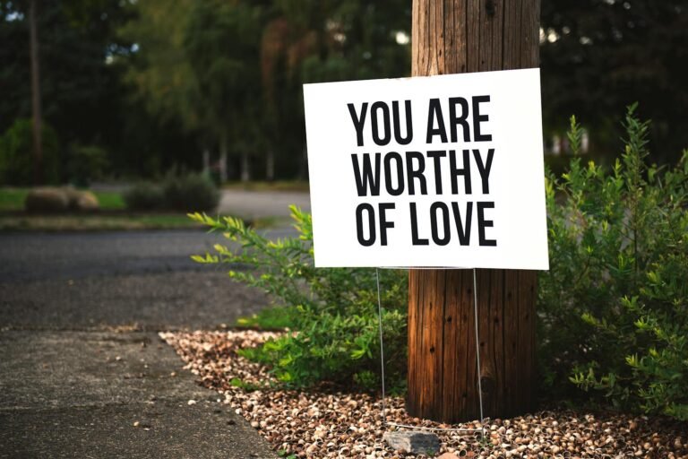 Love and Health Future: 10 Transformative Affirmations to Boost Your Love, Health, and Happiness.(A positive message sign "You are worthy of love" in a park setting.)