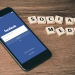 Beyond the Basics: Deepening Connection Through Advanced Digital Detox Strategies..space gray iPhone 6 with Facebook log-in display near Social Media scrabble tiles
