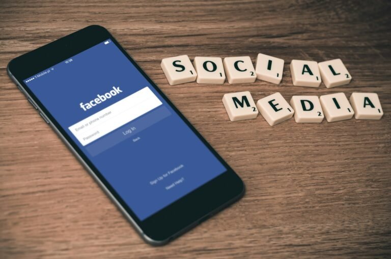 Beyond the Basics: Deepening Connection Through Advanced Digital Detox Strategies..space gray iPhone 6 with Facebook log-in display near Social Media scrabble tiles