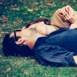 Love and Health: The Interconnected Path to a Fulfilling Future (man and woman lying on grass)