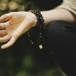 The Transformative Power of Mala Beads: Love, Health, and Spiritual Wellness.(person doing meditation outdoors)