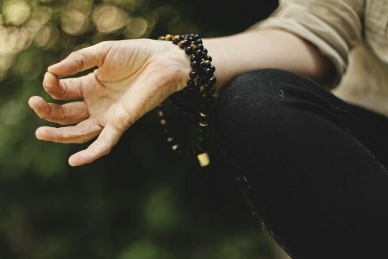 The Transformative Power of Mala Beads: Love, Health, and Spiritual Wellness.(person doing meditation outdoors)