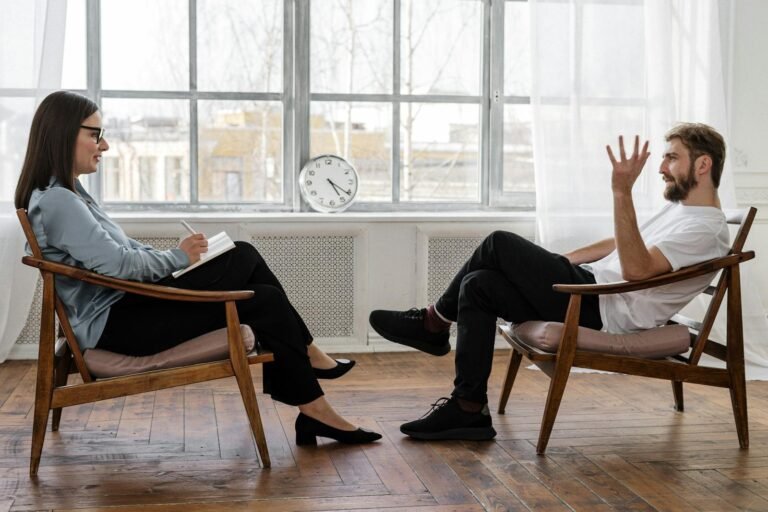 How To Balance Love: Mastering Relationships, Stress, and Health ,A therapist engaging in a counseling session with a male patient to support mental health.