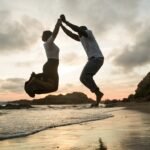 Balancing Love and Health in Australia. Love and health,love, man and a woman jumping on a beach