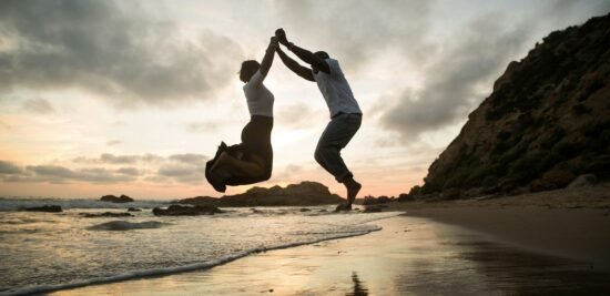 Balancing Love and Health in Australia. Love and health,love, man and a woman jumping on a beach