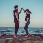 Balanced Love: The Hidden Key to Happiness in Modern Relationships, man and woman standing on rock