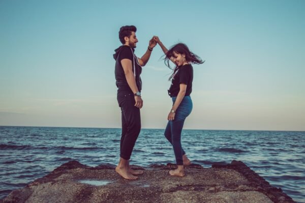 Balanced Love: The Hidden Key to Happiness in Modern Relationships, man and woman standing on rock