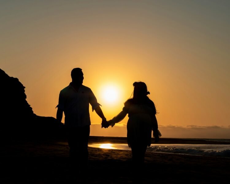 Balanced Love: The Modern Guide to Nurturing Healthy Relationships, How to maintain love in modern relationships , a man and a woman hold hands as the sun sets
