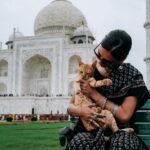 Love and Health in India: A Path to a Brighter Future in 2025 5 Love and Health in India: woman carrying orange tabby cat across white mosque